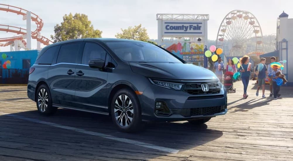 A gray 2026 Honda Odyssey parked near a far.