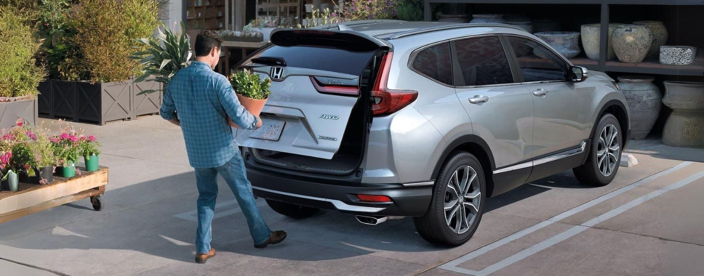 A silver 2021 Honda CR-V Touring with person using power rear lift gate.