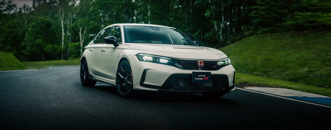 A white 2023 Honda Civic Type R shown driving a racetrack.