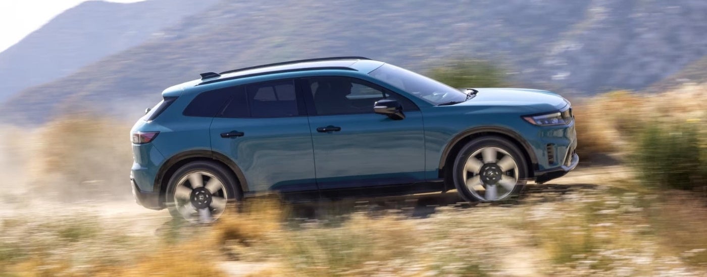 A blue 2024 Honda Prologue Elite shown driving from the side.
