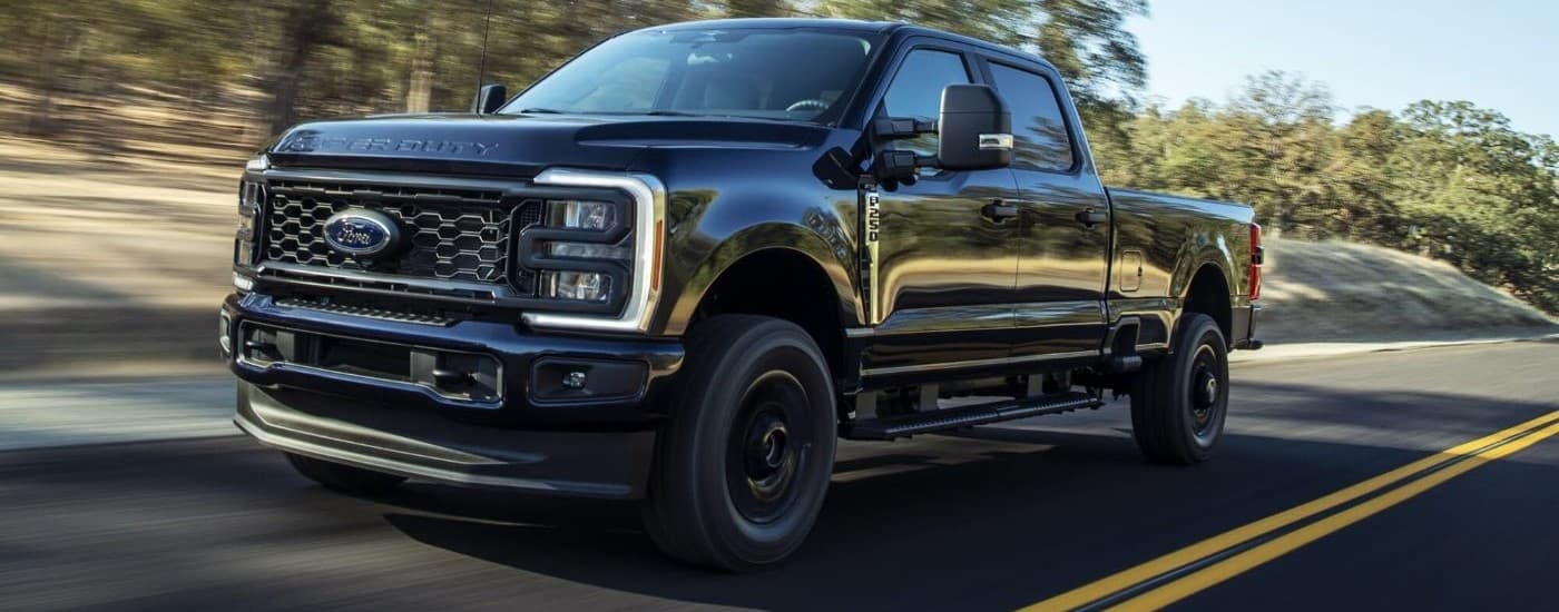 Black Ford F-250 XL STX driving down an open road