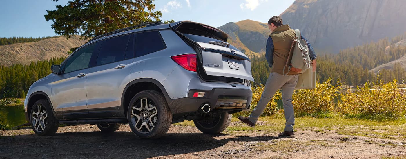 A person using their foot to open the hatch of their 2023 Honda Passport Elite