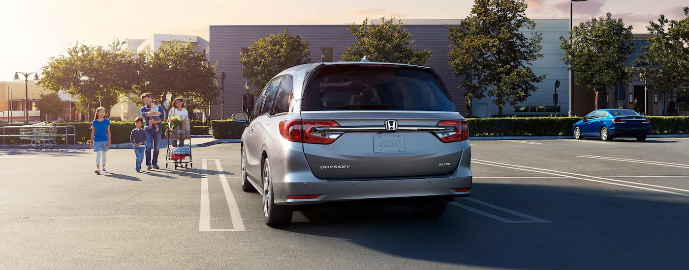 Rear of a silver 2024 Honda Odyssey Elite parked on a parking lot.