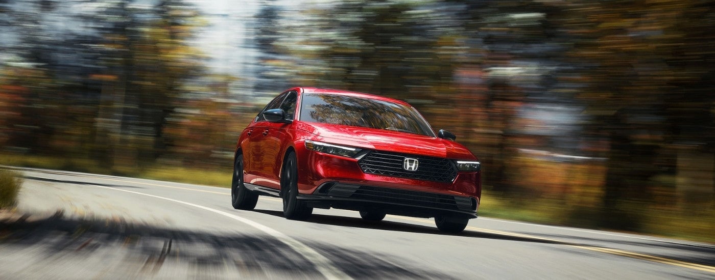 A red 2025 Honda Accord from the front at an angle after leaving a Honda dealer.