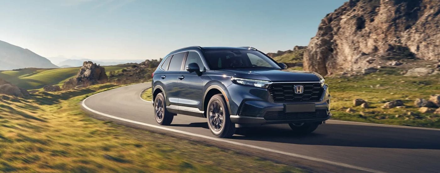 Blue 2026 Honda CR-V rounding a bend