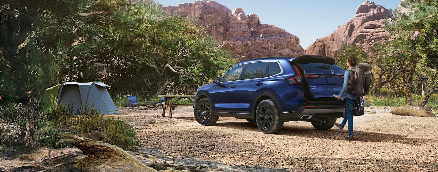 Rear of a dark blue 2026 Honda CR-V Hybrid parked off-road.