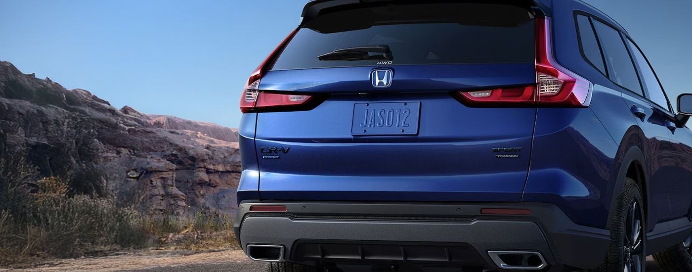 Rear view of a blue 2026 Honda CR-V Hybrid.