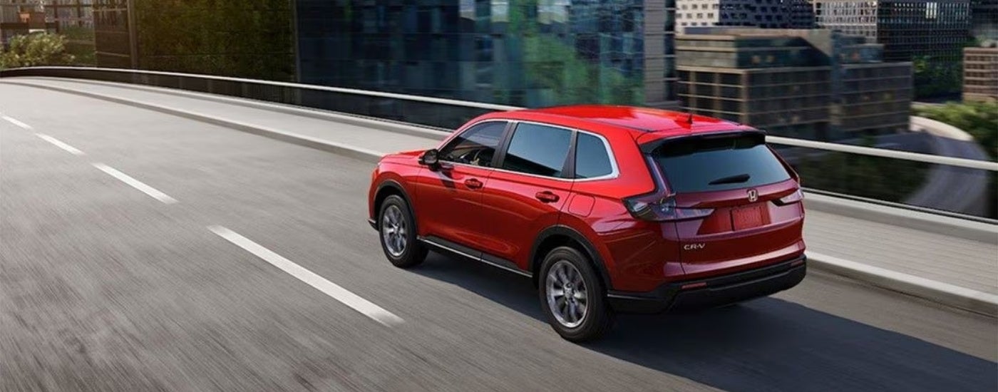 A red 2023 Honda CR-V from the rear at an angle.