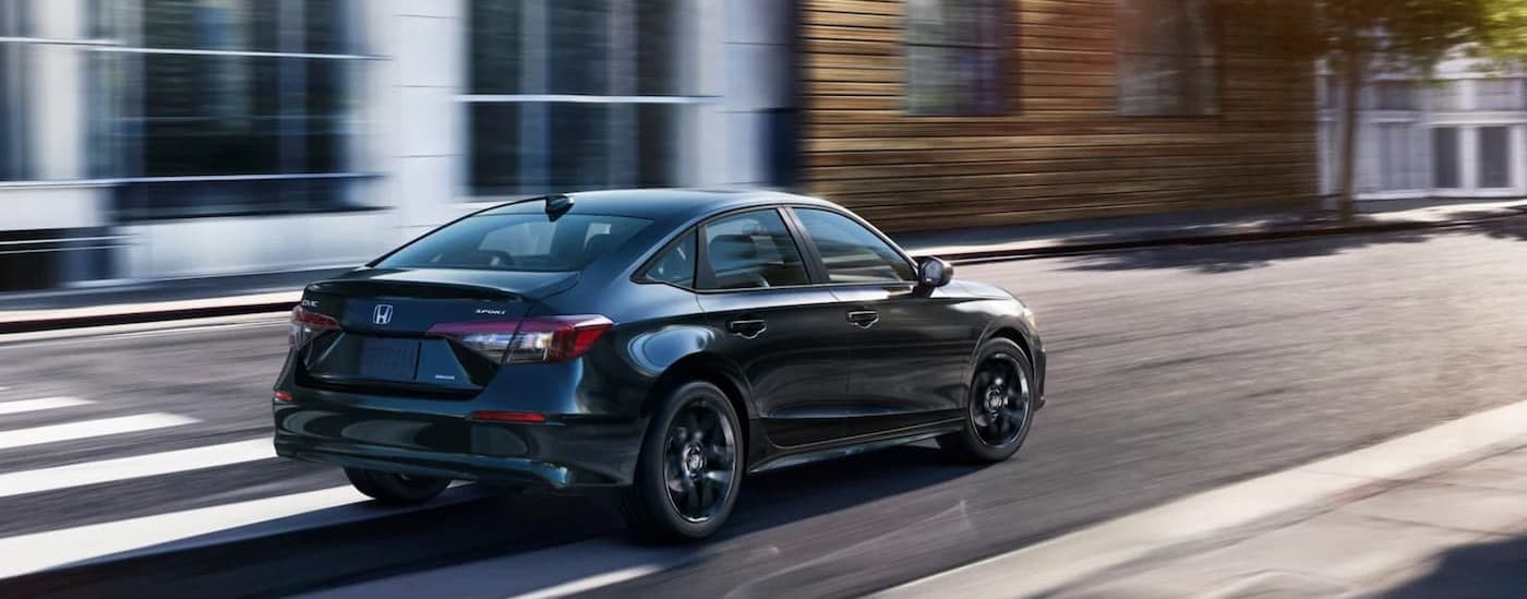 A black 2026 Honda Civic driving in a city.