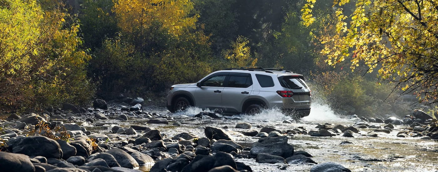 A silver 2025 Honda Pilot from the side.
